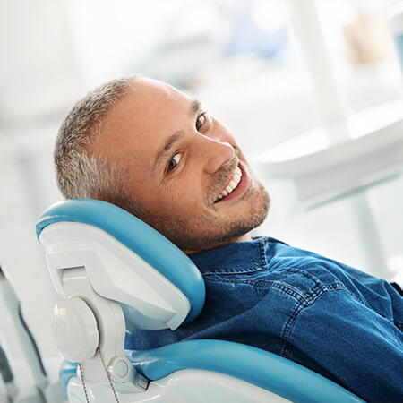 smiling man in dental chair