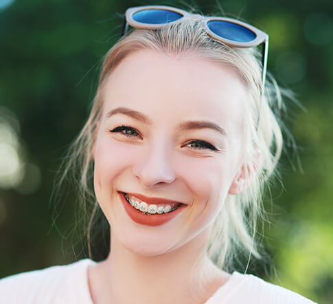 young smiling girl with braces