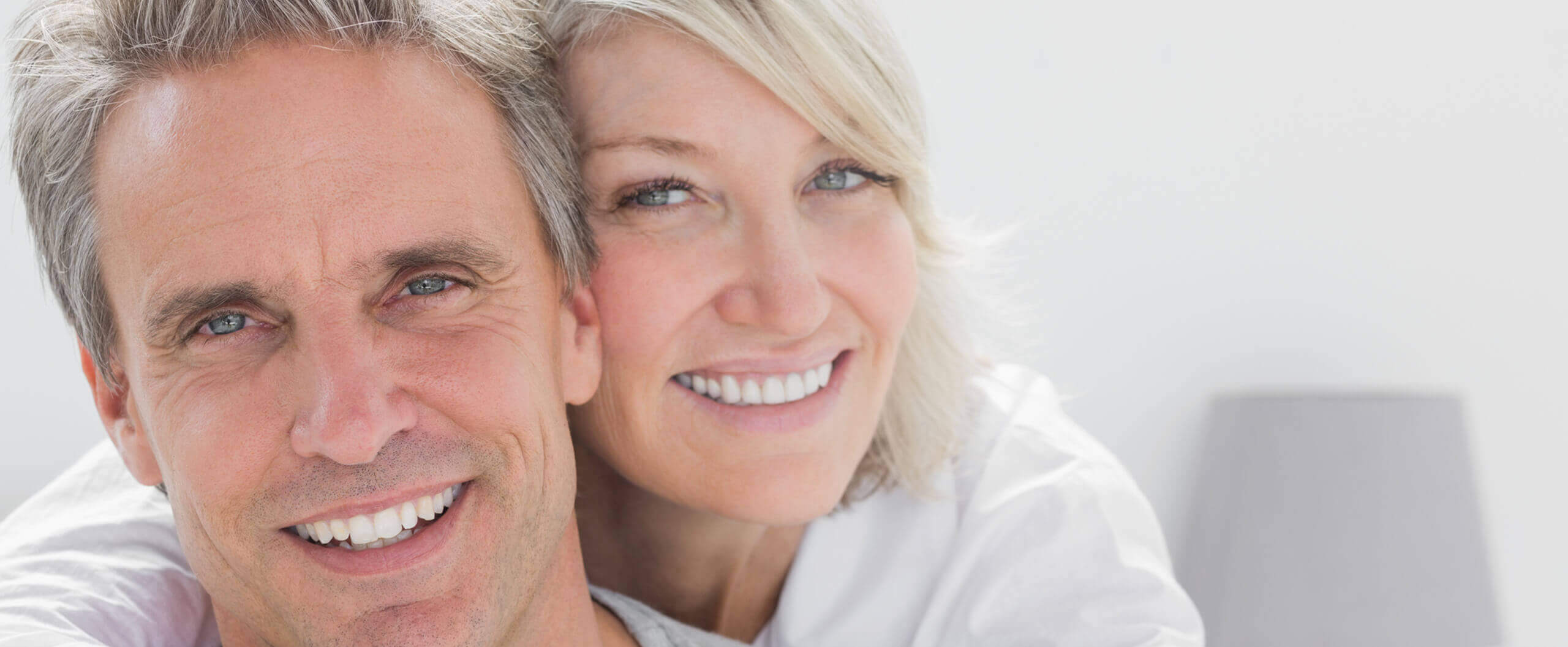 an older couple with veneers smiling