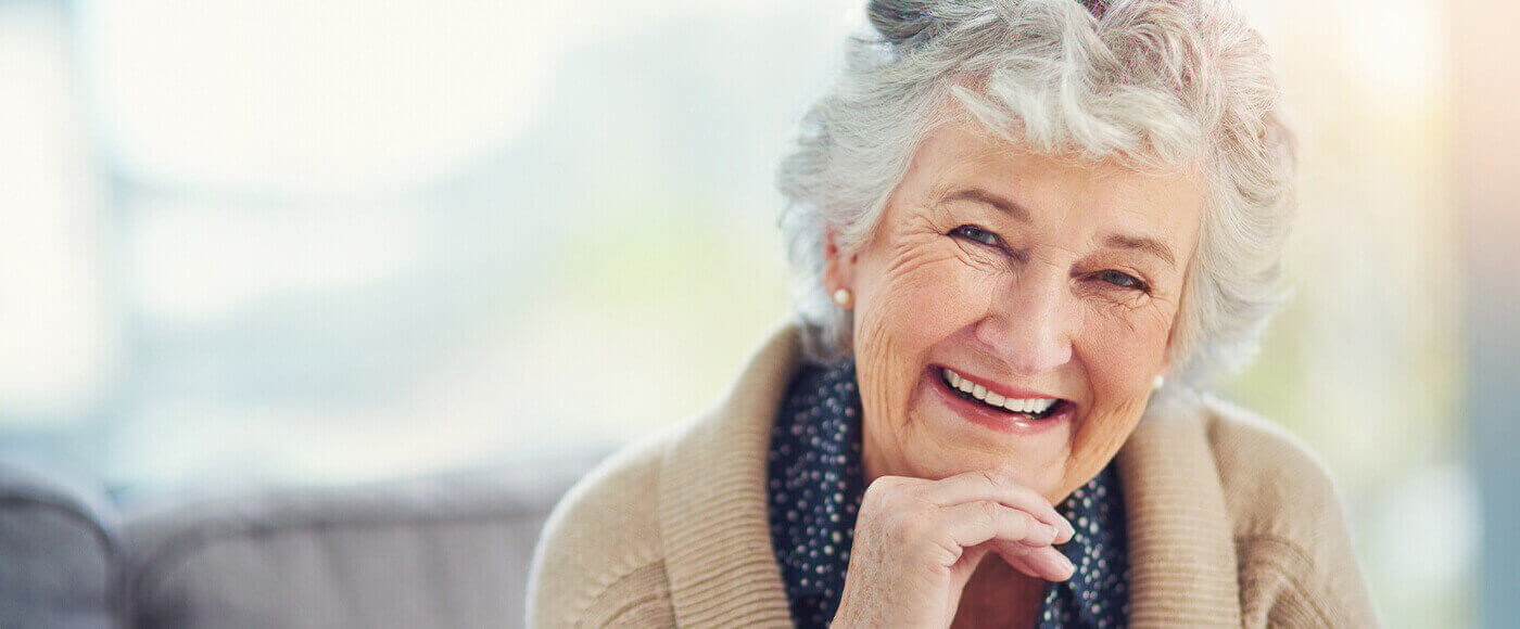 Beautiful elderly woman with dentures smiling