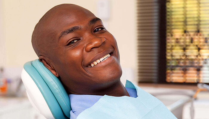 man in dental chair smiling