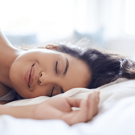 woman laying on bed smiling